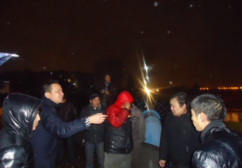 三轮车落入河中 乘客爬上车顶呼救